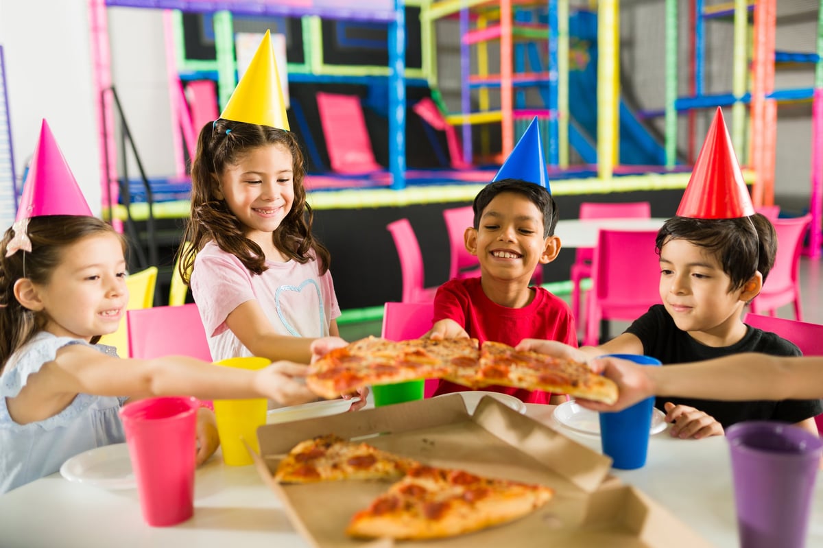 Happy group of kids having fun celebrating a birthday party together