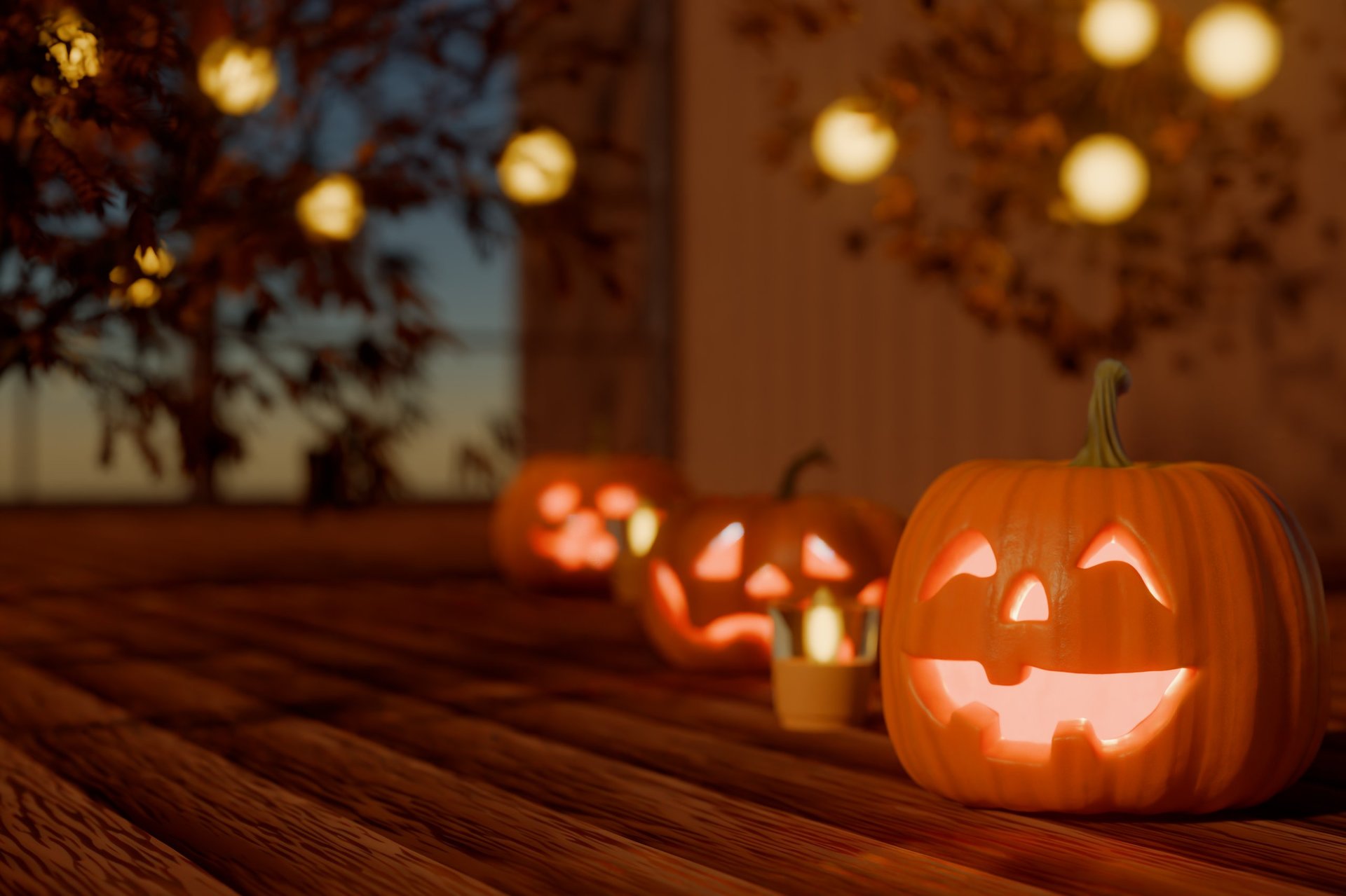 Row of glowing Halloween jack-o'-lanterns lit with warm amber light